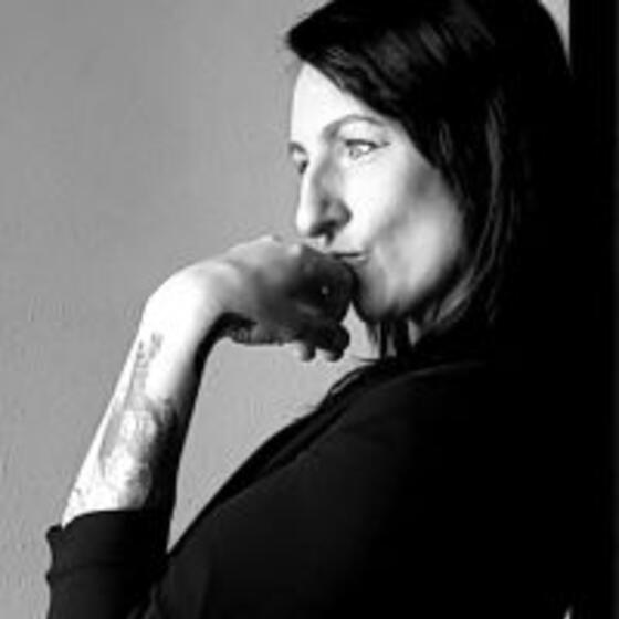 black and white image of Amanda standing with her hand on her chin