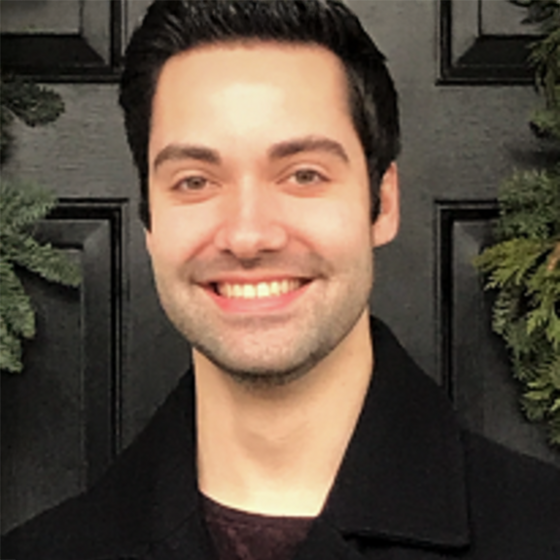Kevin Jensen in a black shirt smiling into the camera