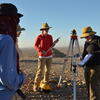 image of instructor with students in Oman at a dig site
