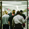 image of prison guards walking students through prison gates
