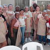 image of a group of study abroad students in a kitchen with locals