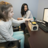 image of research assistant and child participant doing a task on a computer