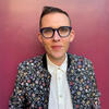 Bench Ansfield in a floral jacket and white shirt staring into the camera