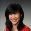 Eunice Chen in a red and white shirt smiling and staring into the camera