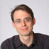 David Nickerson black shirt smiling and staring into the camera