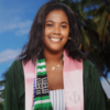 Kerrigan Adkins in a graduation robe smiling into the camera