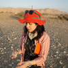 Kimberly Williams looking at a rock in the desert