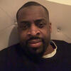 Latif Davis in a black shirt staring into the camera