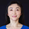 Lu ZhangHamil Pearsall in a blue shirt smiling and staring into the camera