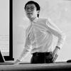 black and white image of Mag standing in a classroom