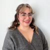 Sara Contreras in a gray sweater smiling into the camera