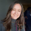 Wendy Thompson in a gray sweater staring into the camera and smiling