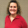 Norma Corrales Martin in a red shirt smiling into the camera