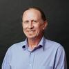 Fletcher Chmara-Huff in a blue shirt smiling and staring into the camera