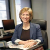 image of Marsha sitting at her desk smiling at the camera