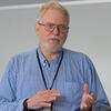 Gerald Stahler in a blue shirt speaking to a class 