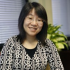 image of hongling sitting at her desk smiling at the camera