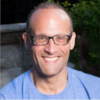 Mark Leuchter is a blue shirt smiling and staring into the camera