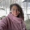 Maura Shenker in a pink coat standing in the snow staring into the camera