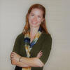 Lauren Farmer in a green shirt with a colorful scraf with her arms crossed Hamil Pearsall smiling and staring into the camera