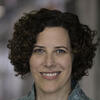 Judith Levine smiling and staring into the camera